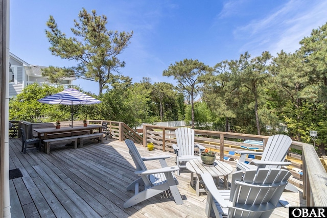wooden deck featuring outdoor dining area