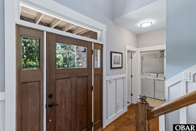 entrance foyer featuring independent washer and dryer and wood finished floors