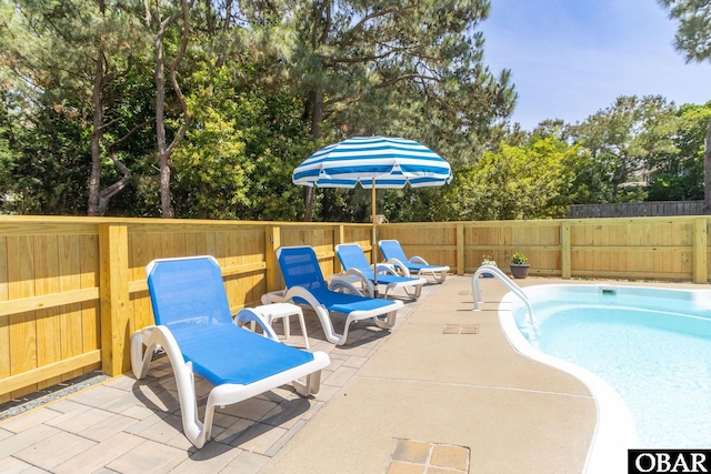 view of swimming pool with a patio area, a fenced in pool, and a fenced backyard