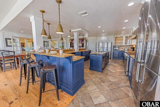1459 Ocean Pearl Rd Lot 2, 3A, 3B, Corolla, NC 27927 - kitchen with stainless steel refrigerator with ice dispenser, blue cabinetry, a large island with sink, freestanding refrigerator, and recessed lighting