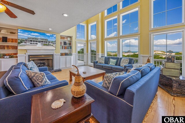 1459 Ocean Pearl Rd Lot 2, 3A, 3B, Corolla, NC 27927 - living area with wood finished floors, a ceiling fan, a fireplace with raised hearth, built in features, and recessed lighting