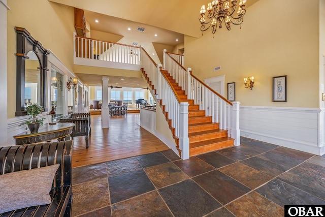 1459 Ocean Pearl Rd Lot 2, 3A, 3B, Corolla, NC 27927 - entrance foyer featuring ornate columns, a high ceiling, stone tile floors, stairs, and a chandelier