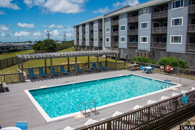 24256 Resort Rodanthe Dr Unit 6B, Rodanthe, NC 27968 - community pool with fence, a pergola, and a wooden deck