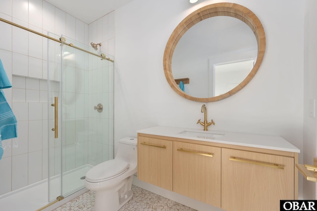 full bathroom with vanity, toilet, and a shower stall