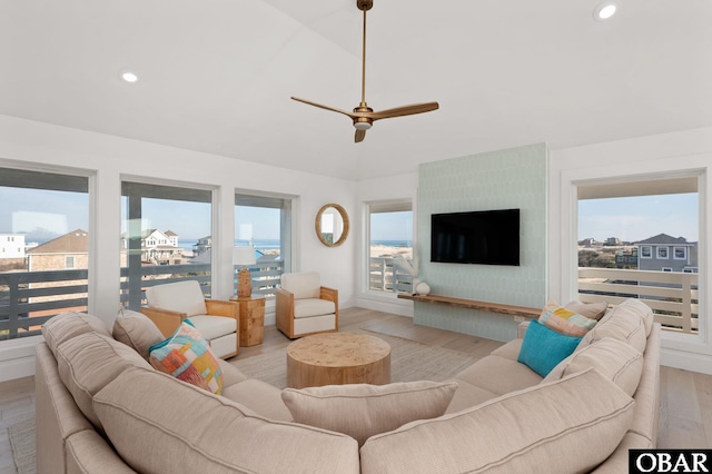 living room featuring light wood-style flooring, recessed lighting, baseboards, ceiling fan, and vaulted ceiling