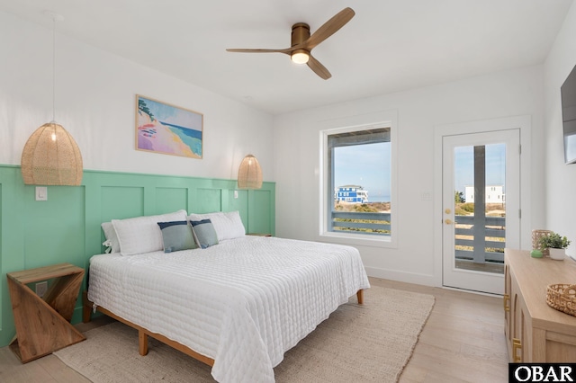 bedroom featuring access to exterior, a ceiling fan, and light wood finished floors