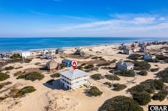 drone / aerial view featuring a view of the beach and a water view