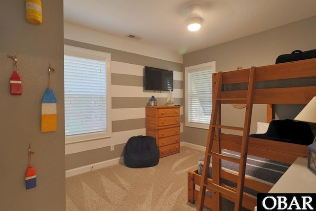 bedroom featuring light carpet, baseboards, and visible vents