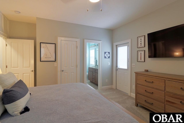 bedroom featuring light carpet, a ceiling fan, and baseboards