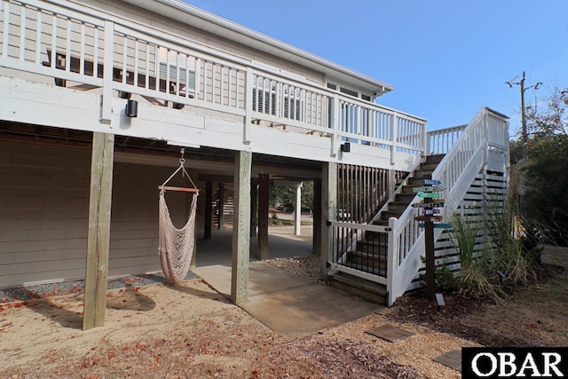 back of house with a deck and stairway