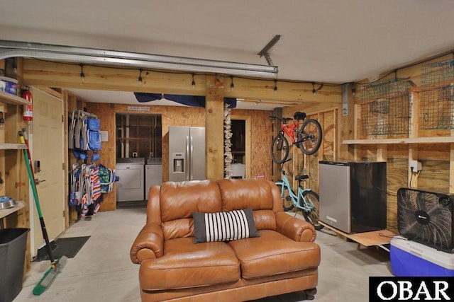 living room with concrete flooring and independent washer and dryer