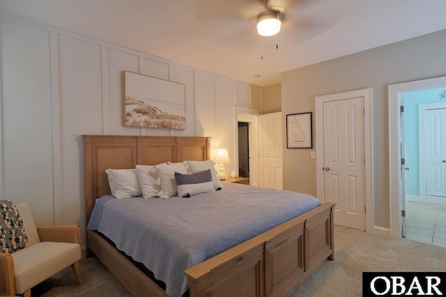 bedroom featuring a ceiling fan and light colored carpet