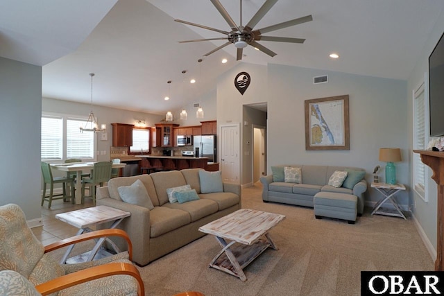 living area featuring baseboards, visible vents, ceiling fan with notable chandelier, high vaulted ceiling, and recessed lighting