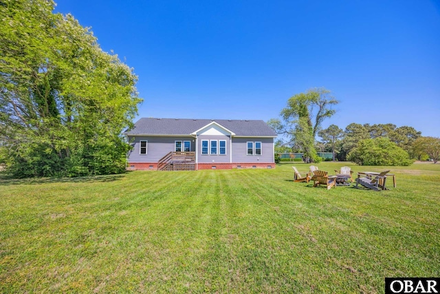 149 Carolina Club Dr Lot 54, Grandy, NC 27939 - back of property with crawl space, a lawn, and an outdoor fire pit