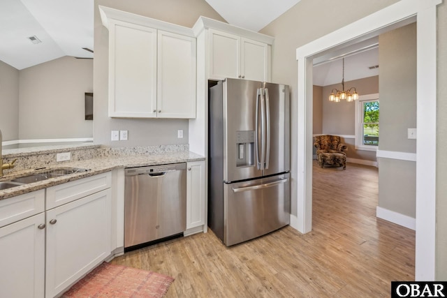 149 Carolina Club Dr Lot 54, Grandy, NC 27939 - kitchen featuring appliances with stainless steel finishes, lofted ceiling, light wood-type flooring, white cabinets, and a chandelier