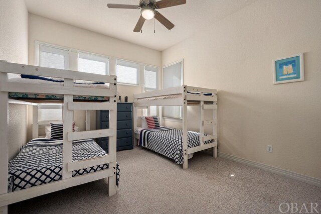 bedroom with light carpet, baseboards, and a ceiling fan