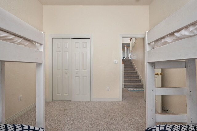 interior space featuring carpet flooring and baseboards