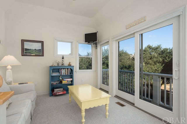 interior space featuring vaulted ceiling, plenty of natural light, and visible vents