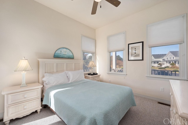 bedroom with light carpet, visible vents, baseboards, and a ceiling fan