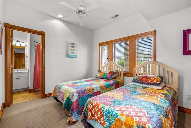 670 Hunt Club Dr Lot 194, Corolla, NC 27927 - bedroom with baseboards, light colored carpet, light tile patterned floors, a textured wall, and a ceiling fan