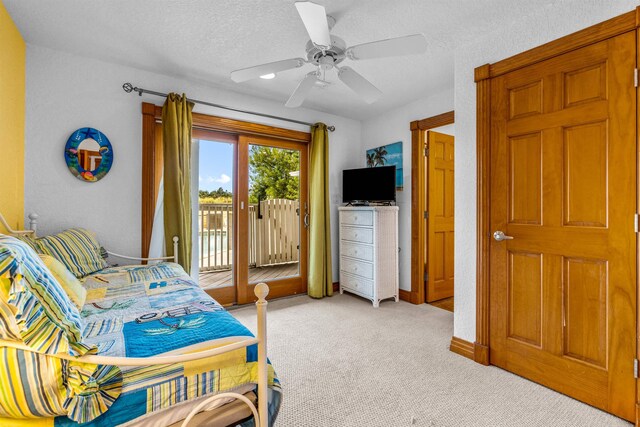 670 Hunt Club Dr Lot 194, Corolla, NC 27927 - bedroom featuring access to exterior, light carpet, a textured ceiling, a ceiling fan, and baseboards