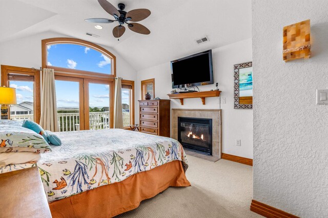 670 Hunt Club Dr Lot 194, Corolla, NC 27927 - carpeted bedroom with lofted ceiling, access to outside, baseboards, a fireplace, and a textured wall
