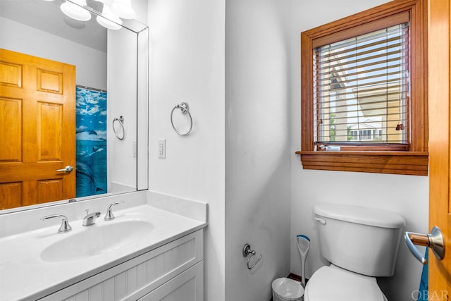 bathroom featuring toilet and vanity