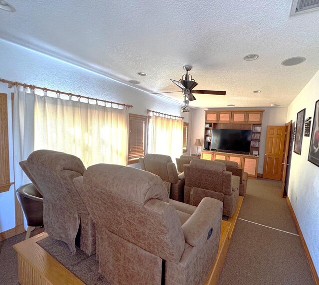670 Hunt Club Dr Lot 194, Corolla, NC 27927 - home theater room with a textured ceiling, baseboards, light carpet, and ceiling fan