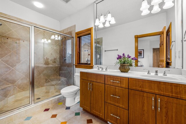 670 Hunt Club Dr Lot 194, Corolla, NC 27927 - full bath with a chandelier, double vanity, toilet, a shower stall, and tile patterned flooring