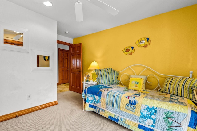 carpeted bedroom featuring ceiling fan and baseboards