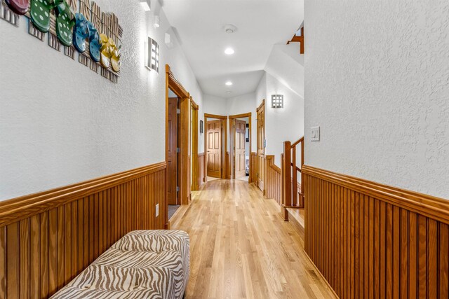 670 Hunt Club Dr Lot 194, Corolla, NC 27927 - corridor featuring a wainscoted wall, an upstairs landing, light wood finished floors, a textured wall, and recessed lighting