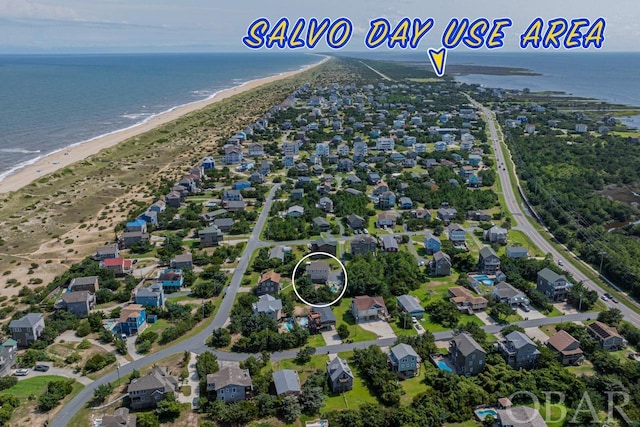 bird's eye view with a beach view, a water view, and a residential view