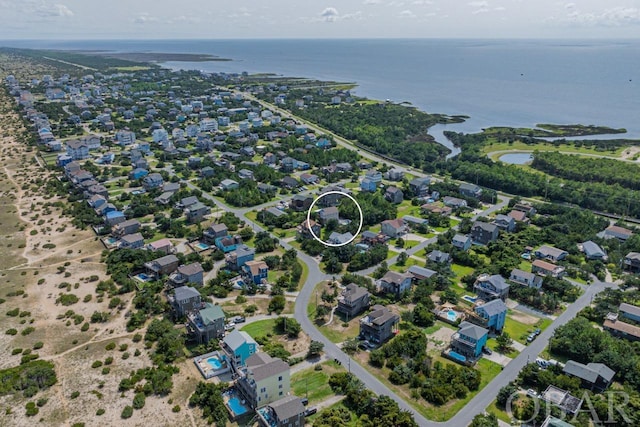 drone / aerial view with a residential view and a water view