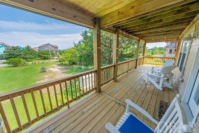 wooden deck featuring a yard