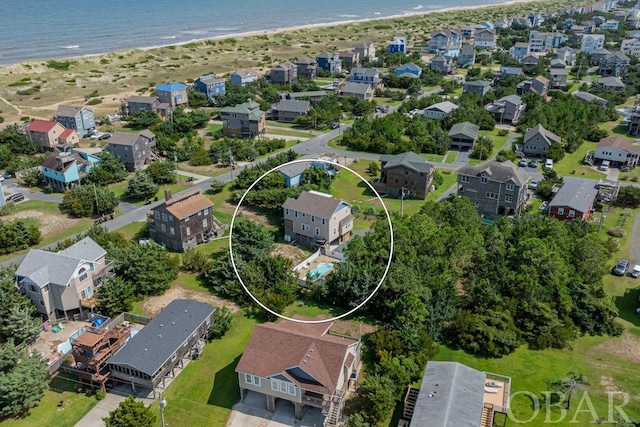 birds eye view of property with a water view, a residential view, and a view of the beach