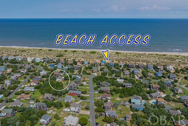 bird's eye view with a residential view, a water view, and a beach view