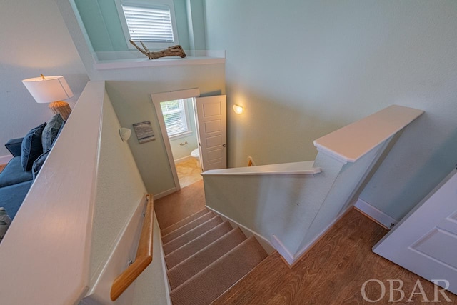 staircase featuring baseboards