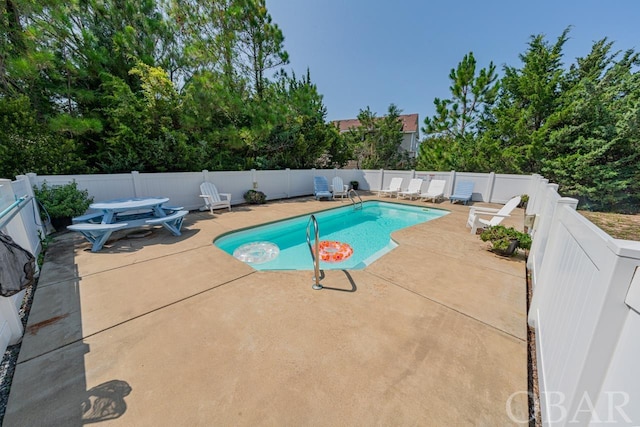 view of pool featuring a patio area, a fenced backyard, and a fenced in pool