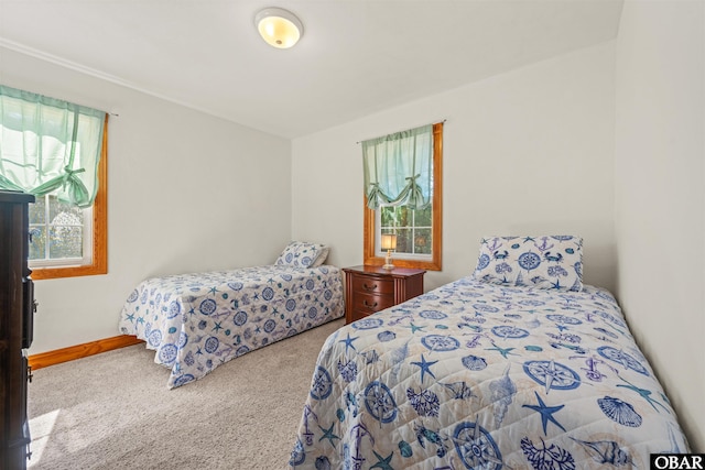 bedroom with baseboards and light colored carpet