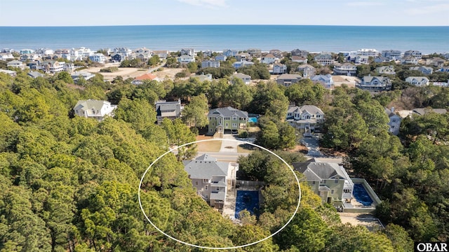 birds eye view of property with a residential view and a water view