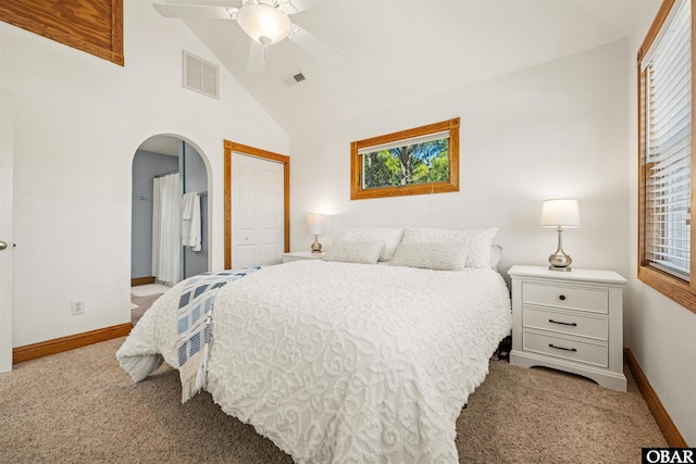 bedroom with light carpet, baseboards, visible vents, arched walkways, and a closet