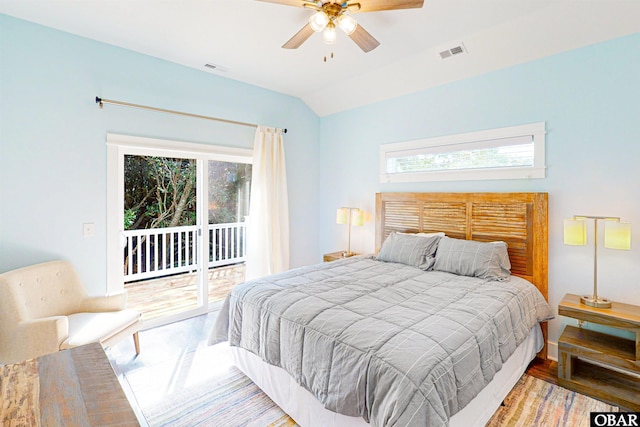 bedroom featuring lofted ceiling, wood finished floors, a ceiling fan, visible vents, and access to exterior