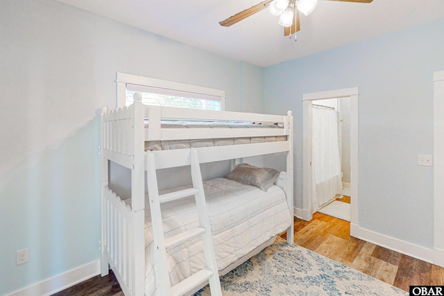 bedroom with a ceiling fan, baseboards, and wood finished floors