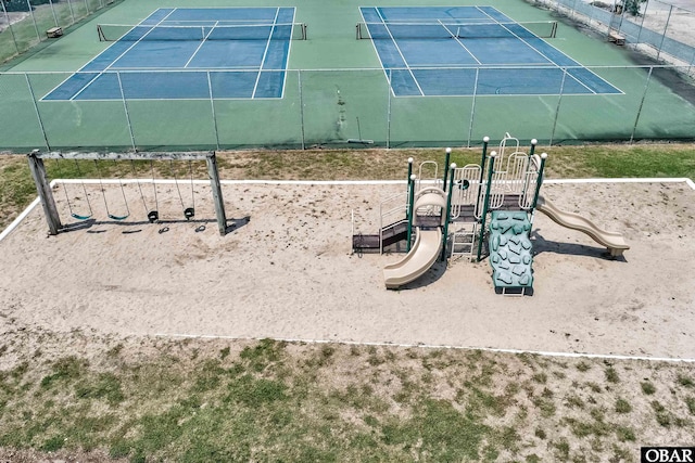 community play area with a tennis court and fence