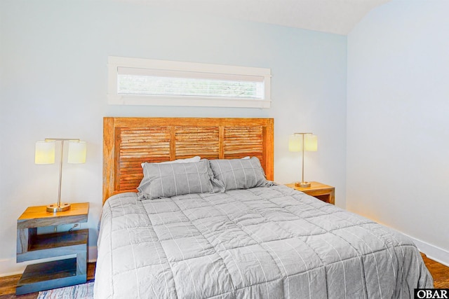 bedroom with baseboards and wood finished floors