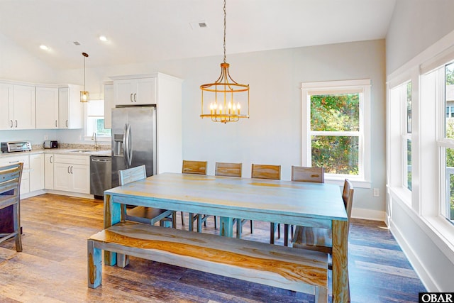 dining room featuring a toaster, recessed lighting, visible vents, light wood finished floors, and an inviting chandelier