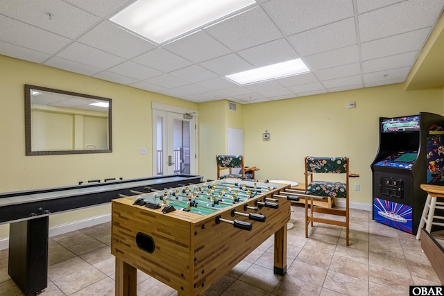 playroom featuring visible vents, baseboards, a drop ceiling, and light tile patterned flooring