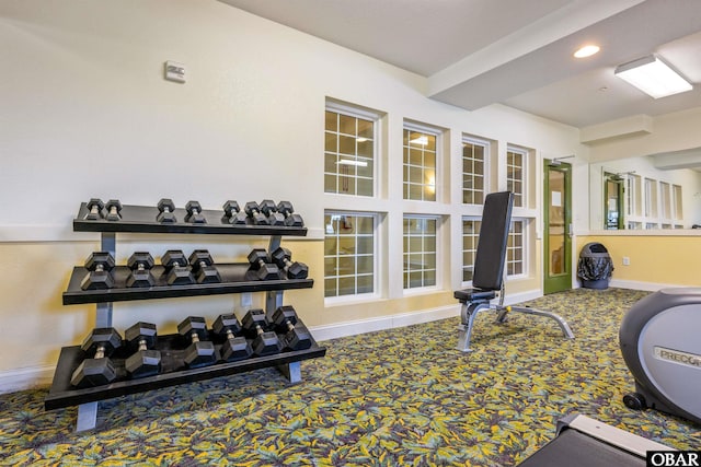 workout room featuring carpet and baseboards