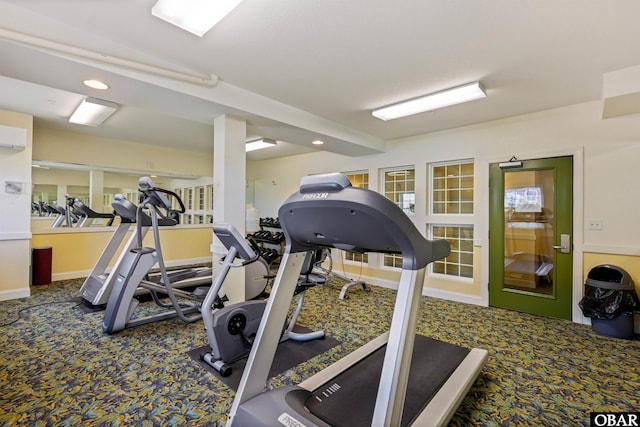 exercise room featuring carpet flooring, baseboards, and a wall mounted AC