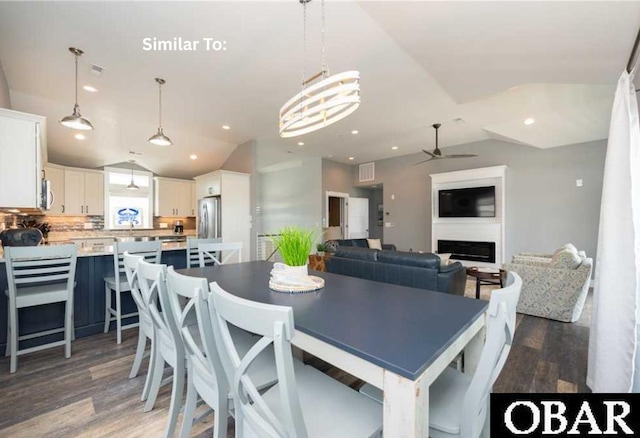 914 Sea Ridge Dr Lot 62, Corolla, NC 27927 - dining area featuring vaulted ceiling, light wood-style floors, ceiling fan, recessed lighting, and a fireplace